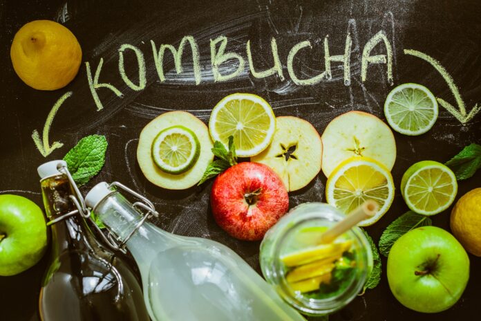 kombucha with lemons in the background