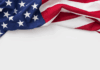 WSJ: Propast mezi růstem zisků firem a růstem mezd je v USA rekordní Partial view of a U.S. flag draped, showing blue field with white stars and red-and-white stripes on white background