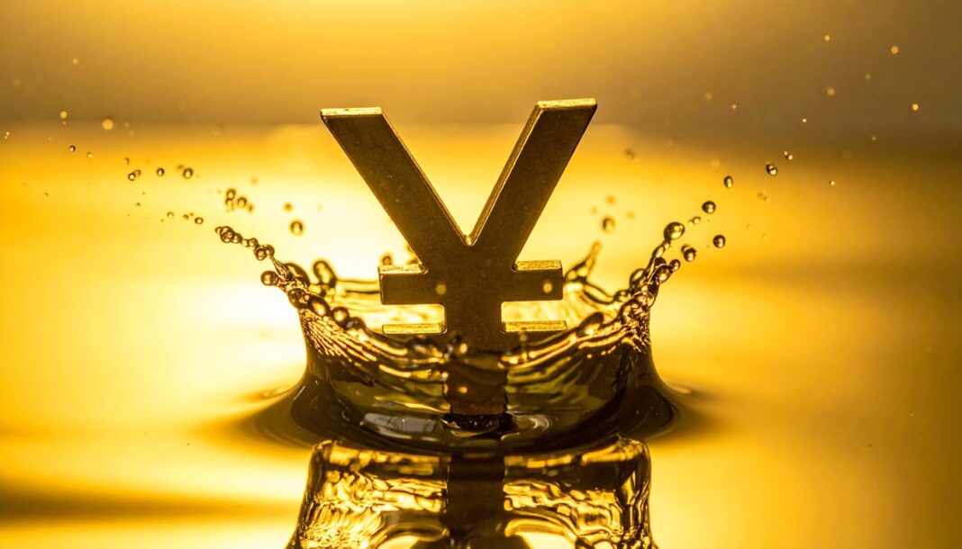 Gold-colored yen symbol rising from a water splash against a warm golden background, creating a crown-like ripple effect.