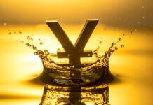 Japan and US jointly intervene to support yen for first time in 15 years Gold-colored yen symbol rising from a water splash against a warm golden background, creating a crown-like ripple effect.